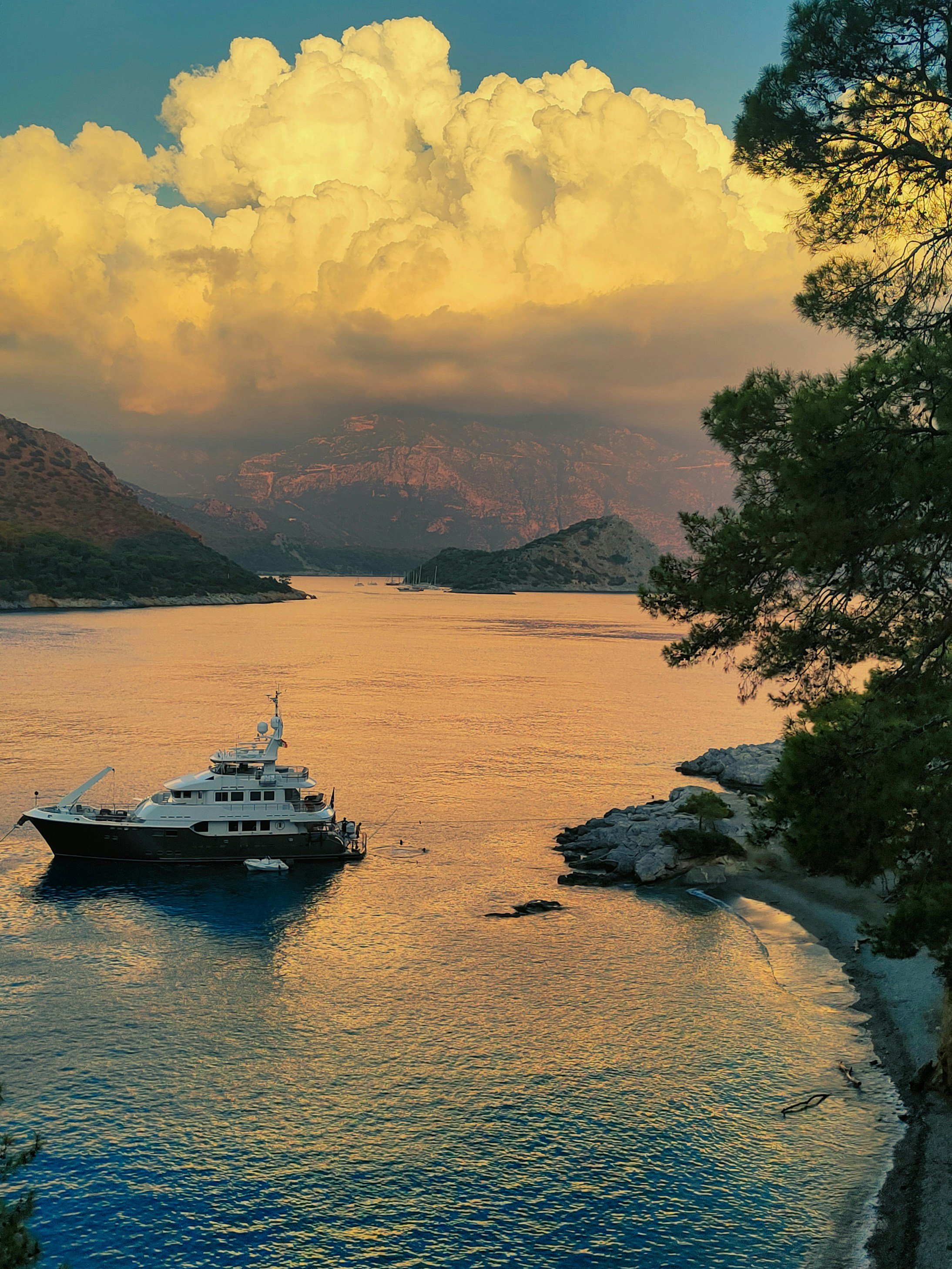 Ship at sea at golden hour with calm water